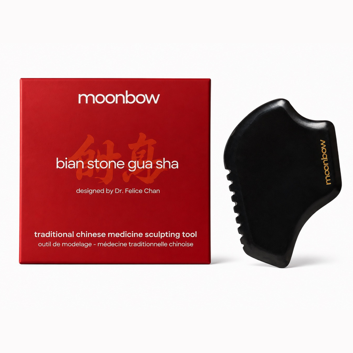 Moonbow Bian Stone Gua Sha set featuring a black stone scraping tool and its red packaging box on a clean white background.